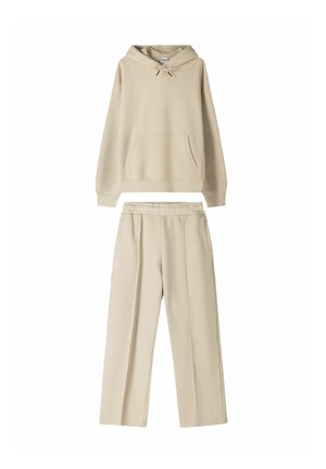 Beige hoodie with a front pocket and drawstring, paired with matching wide-leg pants featuring an elastic waistband and side pockets.