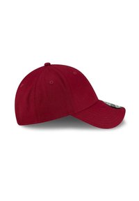 Bordowy sześciopanelowy baseballowy czapka z wyhaftowanymi otworami wentylacyjnymi i zakrzywionym daszkiem, pokazana z boku na białym tle.