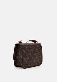 Small structured brown handbag with dark brown patterned logos, a top handle with red accents, set against a white background.