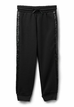 Pantalons de survêtement noirs avec une taille élastique, présentant des panneaux latéraux en sequins noirs brillants et des poignets élastiques aux chevilles.