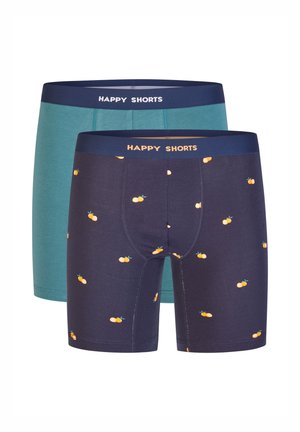 Set mit Boxershorts in einem einfarbigen Teal und einem dunklen Navy mit orangefarbenem Obstprint. Beide Shorts haben "HAPPY SHORTS" auf dem Bund aufgedruckt.