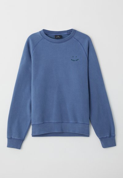 Maglione di cotone blu con maniche raglan, polsini e orlo a costine, caratterizzato da una grafica di un sorriso verde sul petto. Texture morbida.