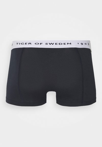 Temno mornarsko modre bokserice z belim pasom, označenim z "TIGER OF SWEDEN" v črni barvi. Imajo gladko teksturo in klasičen kroj.