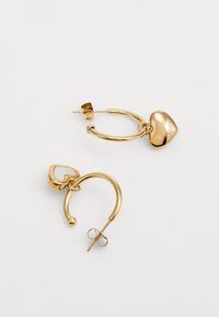 Gold hoop earrings with a heart-shaped charm and a ball accent. Smooth texture, secured by a post and butterfly closure.