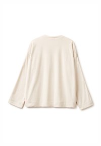 Krémově zbarvená mikina s dlouhými rukávy, volným střihem, kulatým výstřihem a bočními rozparky pro pohodlí. Měkký bavlněný materiál s hladkou texturou.