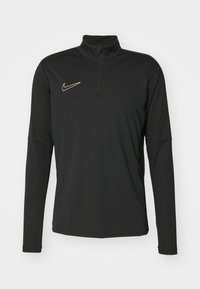 Schwarz langärmliges Sportoberteil mit einem Reißverschluss-Mock-Neck, ausgestattet mit einem goldenen Nike-Logo auf der linken Brust. Hergestellt aus glattem, atmungsaktivem Material.