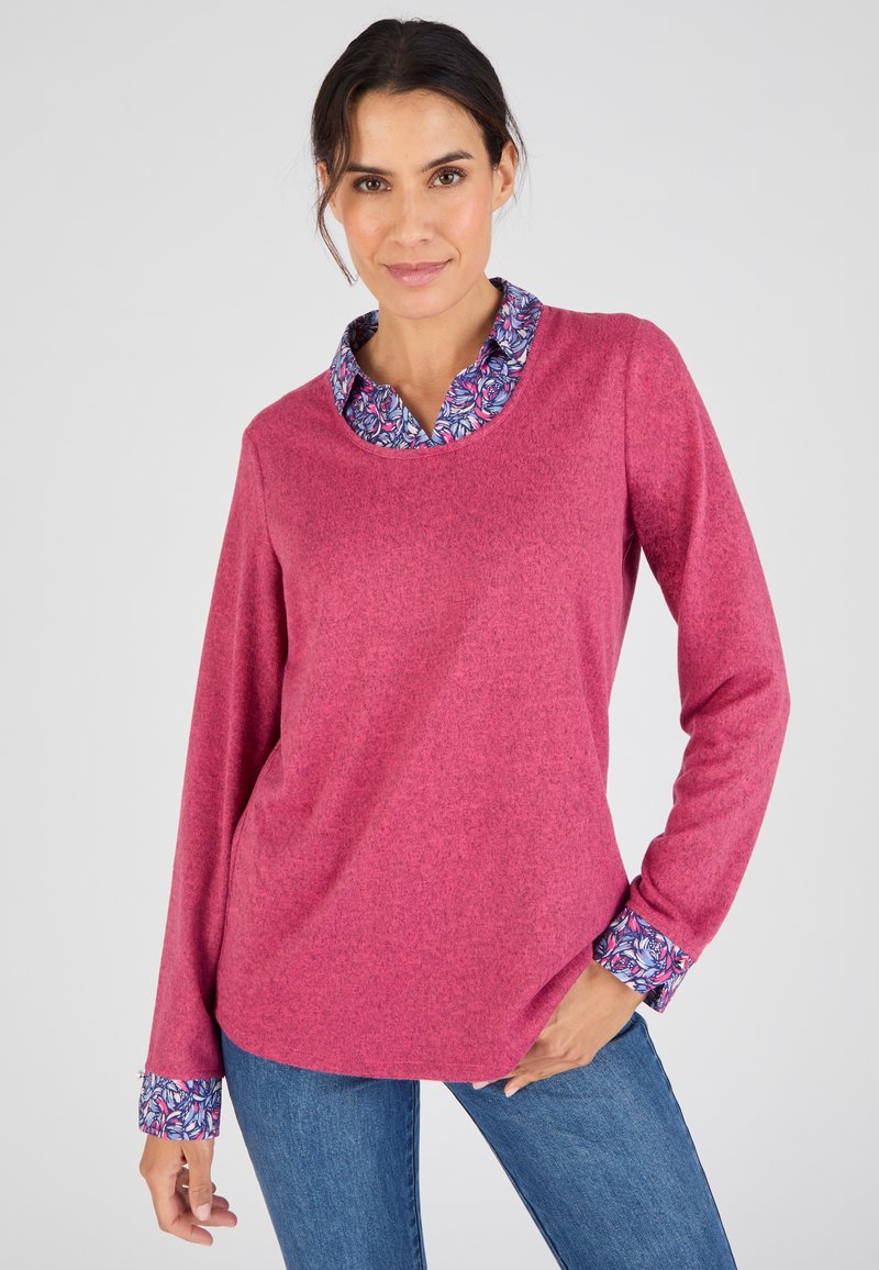 T-shirt à manches longues et col rond en rose chiné, avec un col et des accents de poignets à motif floral bleu. Texture douce et coupe décontractée.