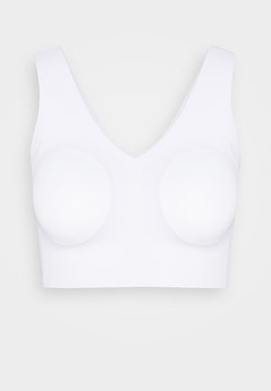 White sports bra with a deep V-neckline, thick shoulder straps, and molded cup pads. Smooth texture and seamless design throughout.