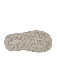 Suela de zapato de goma beige con un patrón texturizado de panal, que presenta formas hexagonales y ranuras horizontales para un mejor agarre.