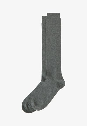 Calze di cotone grigie alte fino al ginocchio con una texture liscia, bordo a coste e design senza cuciture alla punta, adatte per un abbigliamento casual o formale.