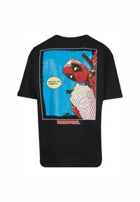 Black T-shirt featuring a colorful Deadpool graphic holding popcorn and a gun, with dialogue bubble and "DEADPOOL" text at the bottom.