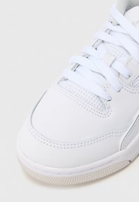 Λευκό δερμάτινο αθλητικό παπούτσι με υφασμάτινα πάνελ με υφή, λευκά επίπεδα κορδόνια, επενδεδυμένο γιακά και ελαστική σόλα με σχεδιασμένη λαβή.