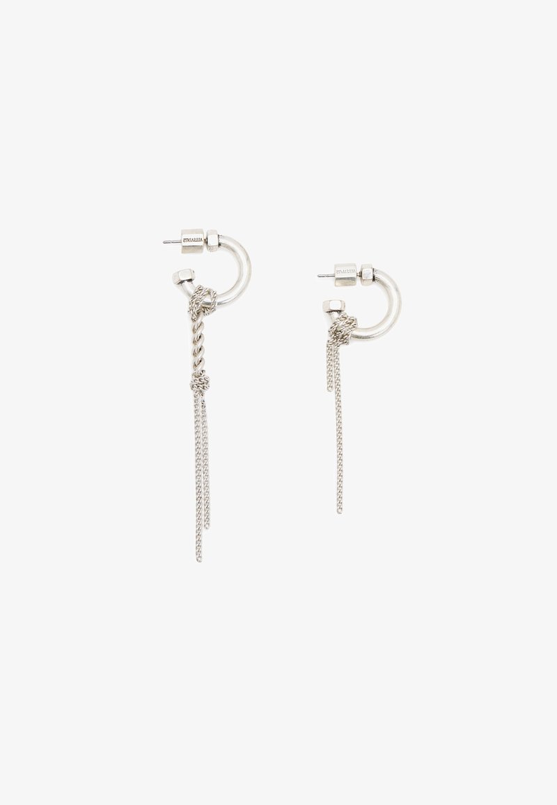 Silver hoop earrings featuring a twisted chain detail with hanging strands, crafted from polished metal with a sleek finish.