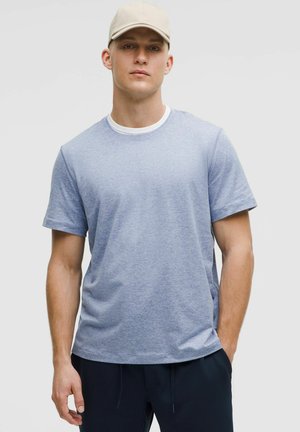 Light blue short-sleeve t-shirt in a soft, breathable fabric with a crew neckline, featured with a white inner collar detail.
