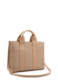 Beige canvas draagtas met twee bovenhandvatten en een afneembare schouderriem. Heeft een gestructureerde vorm en soepele leren accenten.