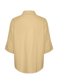 Light yellow, loose-fitting shirt with a collar and three-quarter sleeves. Smooth texture, straight hem, and minimal detailing.