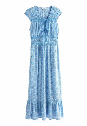 Blue and white patterned sleeveless maxi dress with gathered waist, front tie neckline, and ruffled hem.