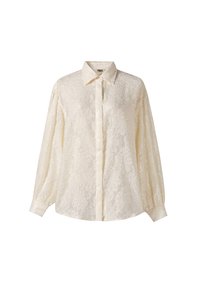 Langarmige ivoorkleurige blouse met een getextureerd bloemmotief, knopen aan de voorkant en een losse pasvorm. Voorzien van een klassieke kraag en elastische manchetten.