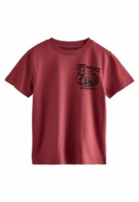 Punainen puuvillainen t-paita lyhyillä hihoilla, jossa on musta dinosauruskuva ja teksti "TYRANT LIZARD MONTANA USA" edessä.