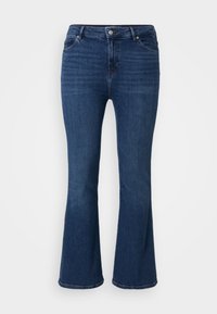 Vaqueros acampanados de color azul oscuro, confeccionados en denim, con diseño de cinco bolsillos y cierre de cremallera. La tela tiene una ligera textura y un acabado clásico.