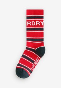 Punane sokk mustade ja valgete triipudega, musta varba ja kannaosaga, millel on brändinimi "Superdry" valge värviga jalas ja sääreosas.
