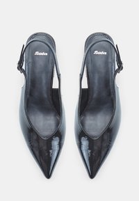 Black patent leather slingback shoes with pointed toe and open sides. Features an adjustable buckle and "Bata" logo on the insole.