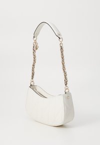 Quilted white handbag with a curved shape, silver hardware, and a chain strap. The exterior features diamond patterns and a zip closure.