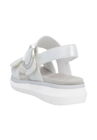 White open-toe sandal with perforated upper, silver hardware accent, and cushioned insole. Features adjustable straps and a thick white sole.