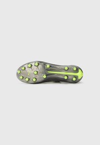 Sole di scarpone da calcio nera con spine allungate; presenta un design testurizzato e vivaci accenti verdi vicino al tallone e agli spiagge.