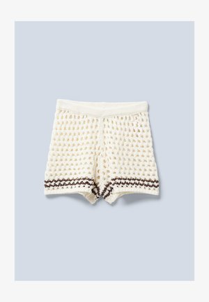 Knit shorts in cream with a textured pattern, featuring a brown striped detail at the hem and a wide elastic waistband.