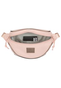 Pink fabric waist bag with a smooth texture, a zippered closure, inner compartments, and a brown logo patch. Adjustable strap included.