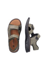 Sandales vertes et beiges avec des brides ajustables en Velcro, semelle rembourrée, semelle en caoutchouc et découpes sur les côtés pour la respirabilité.