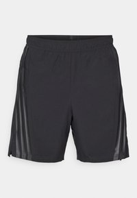 Schwarze Sportshorts aus leichtem Material, mit elastischem Bund, Seitenschlitzen und transparenten Paneelen entlang der Seiten.