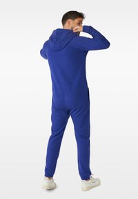 Blue hooded onesie made of soft fabric, featuring long sleeves, elastic cuffs, and side pockets. Back design includes a seamless look.