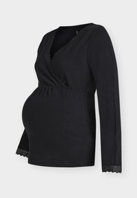 Czarna bluzka ciążowa z długimi rękawami, kopertowym krojem, koronkową lamówką przy dekolcie i na dole, elastyczna bawełniana tkanina, podkreśla kształt brzucha.