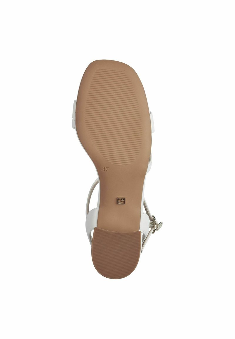 Sandale blanche avec une tige lisse, une bande de cheville réglable et une semelle en caoutchouc marron striée. Taille 37 indiquée sur la semelle.