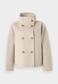 Μπεζ μάλλινο σακάκι διπλής σειράς με ψηλό γιακά και έξι καφέ κουμπιά, μακριά μανίκια και φαρδιά εφαρμογή.