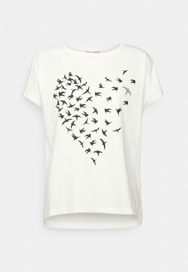T-shirt blanc à manches courtes avec des oiseaux noirs formant un cœur, un oiseau en gris clair s'envole à droite.