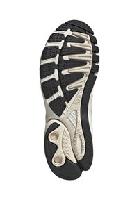 Čierna a béžová športová obuv so podrážkou s textúrovanými gripovými vzormi a detailmi odpruženia, navrhnutá pre trakciu a podporu.