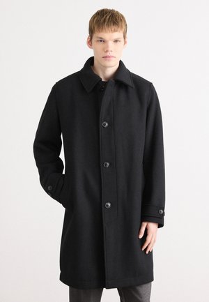 Manteau noir en laine avec un col, des boutons sur le devant et des poches latérales. Présente une coupe droite et un tissu texturé.