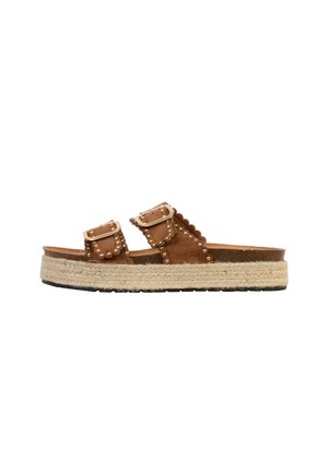 Brown platform slide sandal with jute sole, two buckle straps, and gold stud detailing along edges.