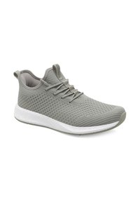 Zapatilla deportiva gris con parte superior de malla transpirable, patrón texturizado, cordones planos y suela blanca acolchada. Diseño de punta redondeada.