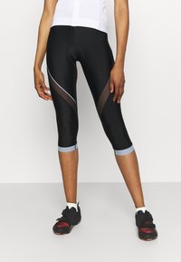 Leggings neri a metà polpaccio con inserti in rete e dettagli azzurri chiari all'orlo. Il materiale sembra essere elastico e aderente, ideale per l'abbigliamento sportivo.