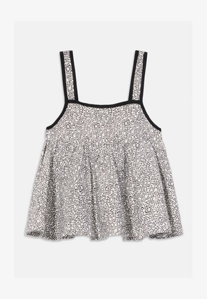 Valge varrukateta pluus musta abstraktse täpilise mustri ja musta ääristusega rihmadel ja kaelusel, kogutud vöökoht laienemiseks.