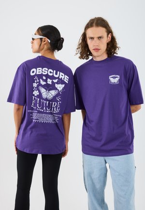 Purple cotton t-shirts featuring front and back prints. The back has "OBSCURE FUTURE" text and butterfly designs; short sleeves, oversized fit.