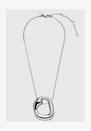 Silver chain necklace with a smooth, irregular heart-shaped pendant. Pendant features a polished finish and open center design.