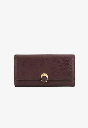Dark brown leather wallet, rectangular shape, features a gold-tone circular clasp, textured surface, and stitched edges for detail.