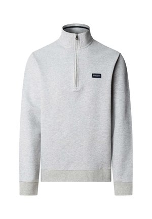 Svijetlosivi pulover s dugim rukavima, četvrtastim patentnim zatvaračem i uspravnim ovratnikom, s malom tamnom pravokutnom logotipnom značkom na prsima.