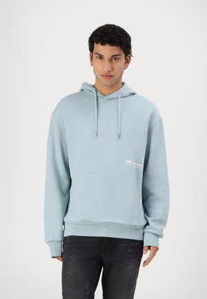 Light blue hoodie with a front pocket and drawstring hood. Features ribbed cuffs and hem, and a white logo print on the chest.