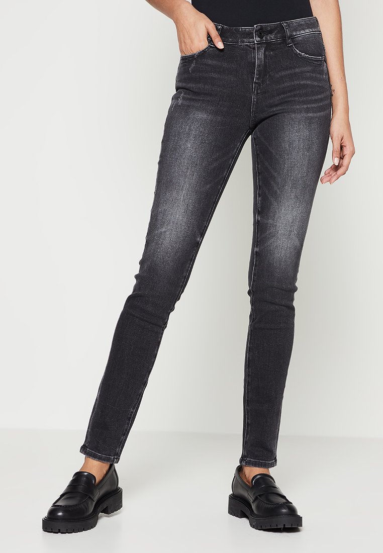 Zwarte denim skinny jeans met een vervaagde afwerking, voorzien van vijf zakken en een klassieke knoopsluiting. Soepele textuur en een slim fit ontwerp.